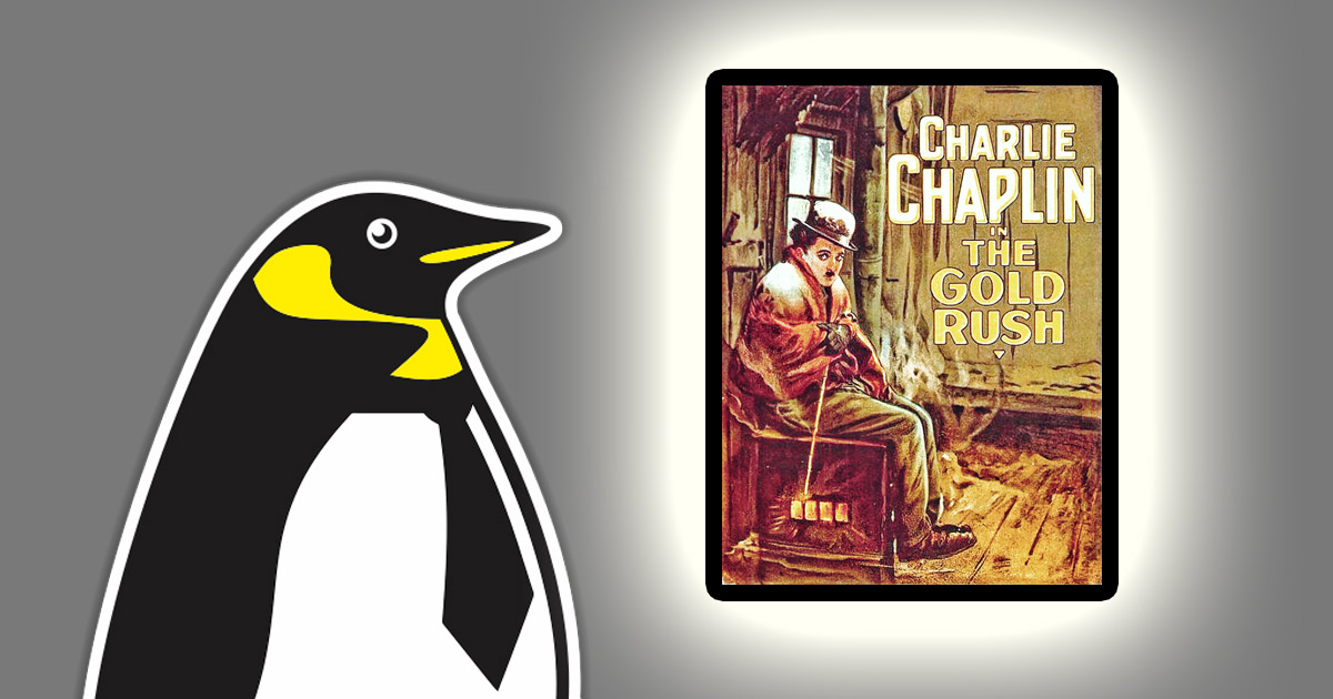 MEB penguin mascot next to a backlit advertising poster for Charlie Chaplin's movie ''The Gold Rush''