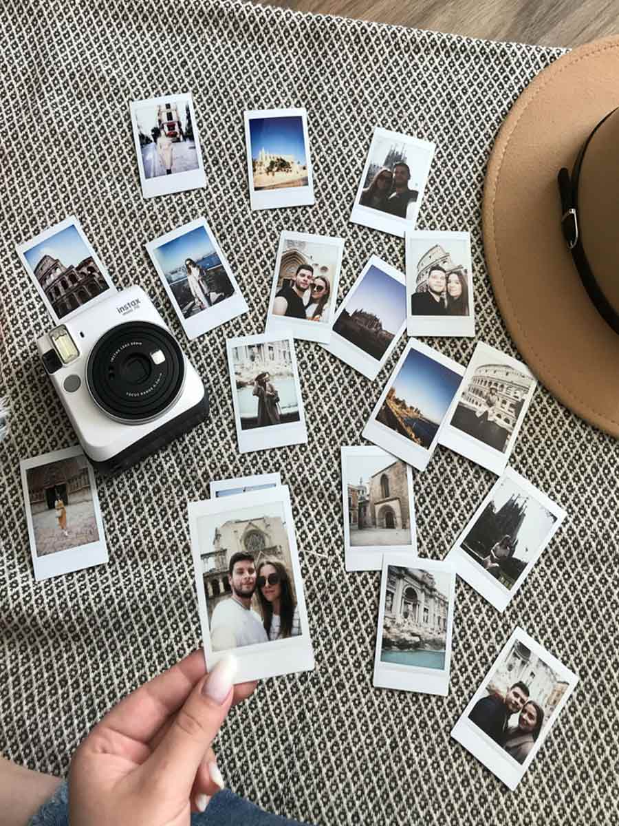 polaroid pictures on the floor with someone inspecting them