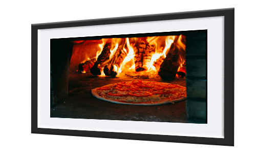 A framed decorative poster of a pizza in a traditional pizza oven